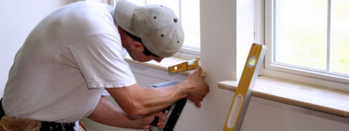 Man working on window sill