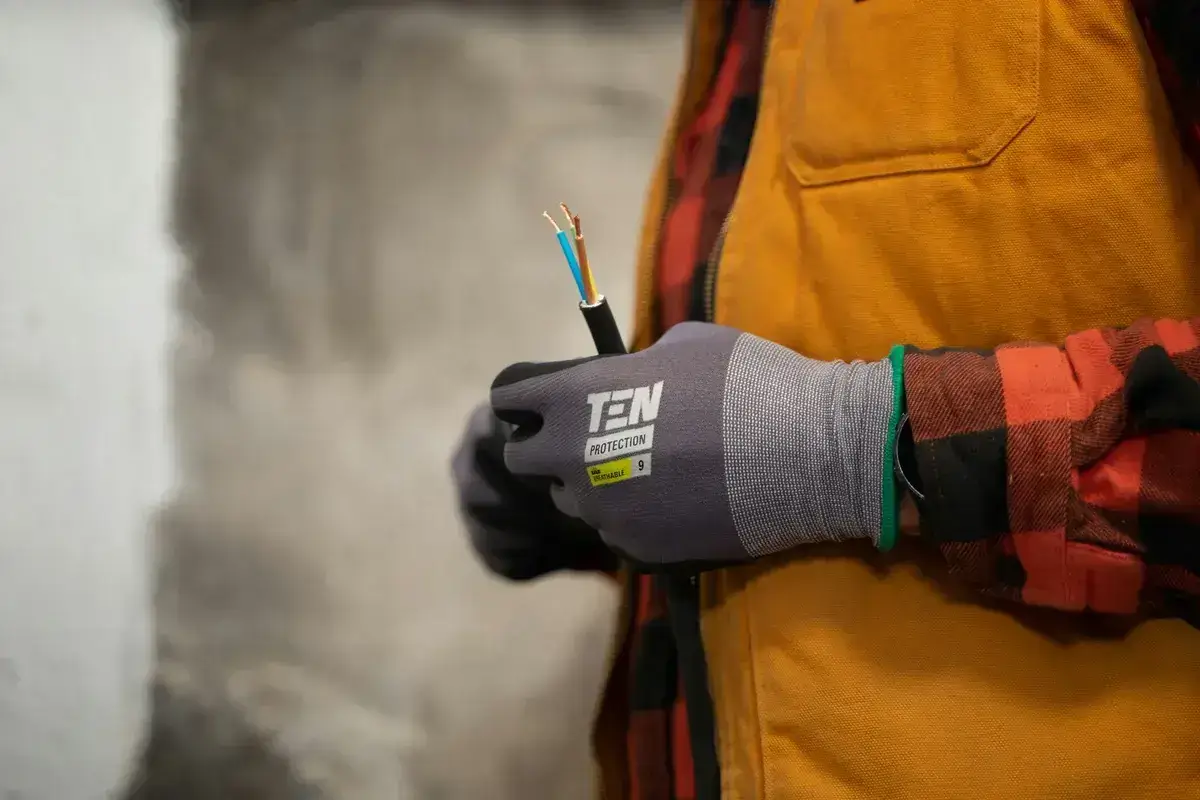 Electrician preparing cables with protective gloves